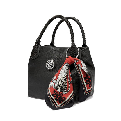 Brighton black leather handbag with braided handles, silver-tone medallion, and red floral print scarf on a white background