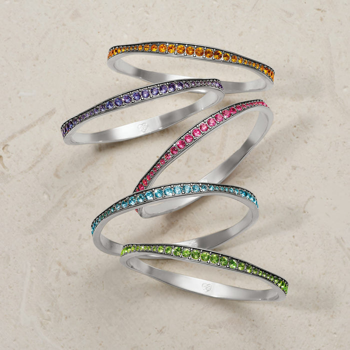 Brighton stacked bangle bracelets with orange, purple, pink, blue, and green crystal rows and silver-plated finish on a white background