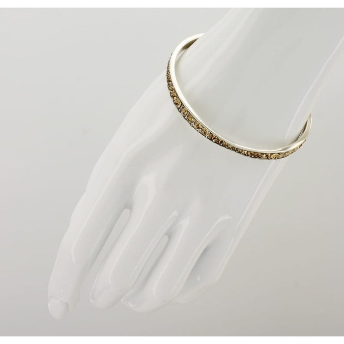 Brighton stack of five silver-plated bangles with orange, purple, pink, blue, and green crystals on a white background
