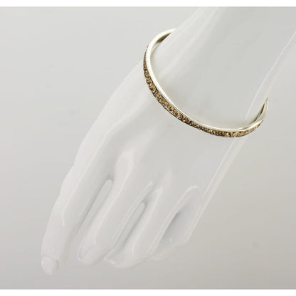 Brighton stack of five silver-plated bangles with orange, purple, pink, blue, and green crystals on a white background