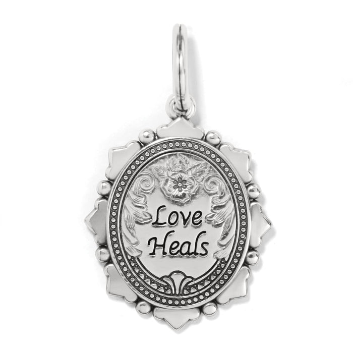 Brighton oval charm pendant engraved with Love Heals and floral scrollwork in silver-tone finish on a white background