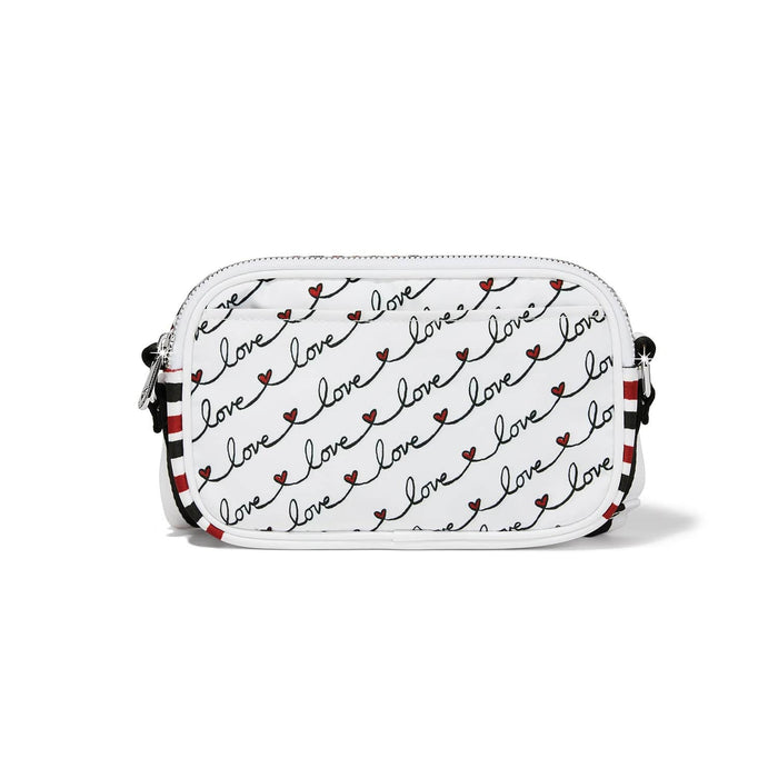 Brighton crossbody handbag shown from the back with repeating love script print and striped strap on a white background