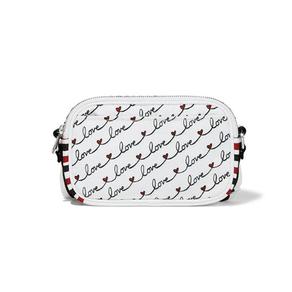Brighton crossbody handbag shown from the back with repeating love script print and striped strap on a white background