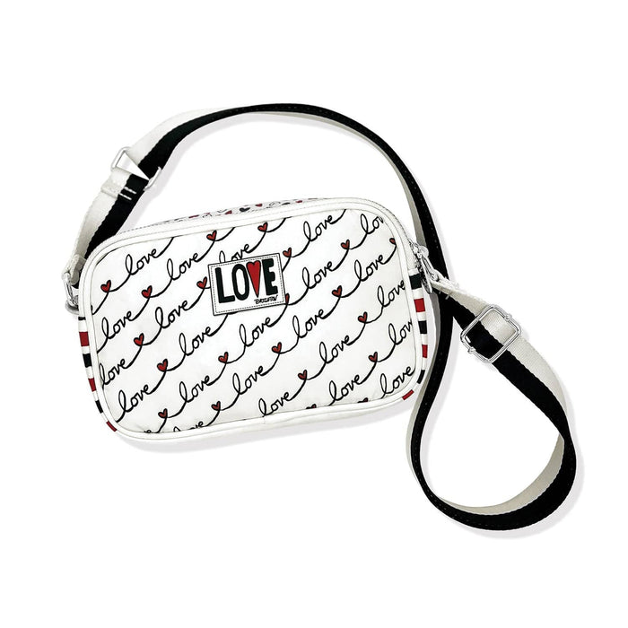 Brighton crossbody handbag with white love script print, red striped sides, and adjustable black strap on a white background