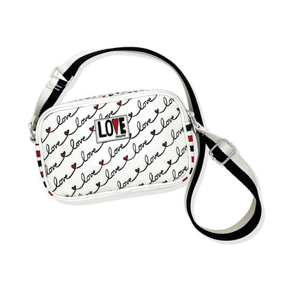 Brighton crossbody handbag with white love script print, red striped sides, and adjustable black strap on a white background