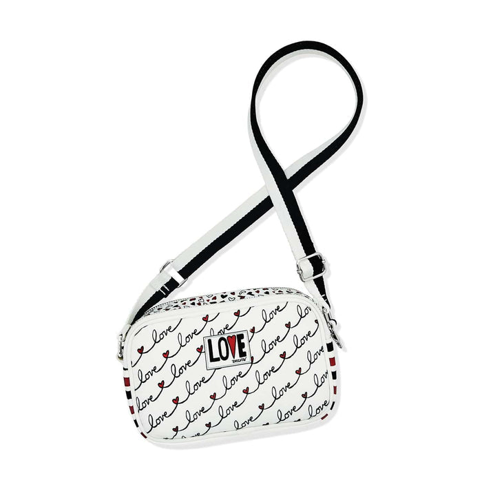 Brighton crossbody handbag with white love script print, heart accents, and black adjustable strap on a white background