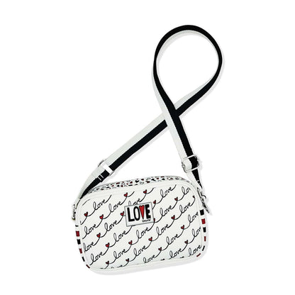 Brighton crossbody handbag with white love script print, heart accents, and black adjustable strap on a white background