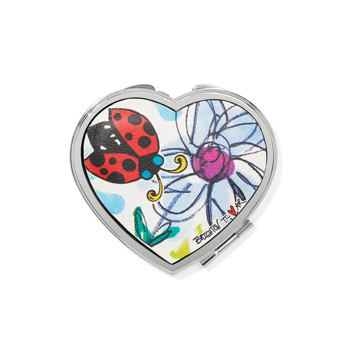 Brighton heart-shaped compact mirror with illustrated ladybug and blue flower print and silver-tone frame on a white background