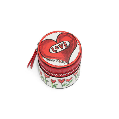 Brighton round leather jewelry case with illustrated red heart, love graphic, and floral print on a white background