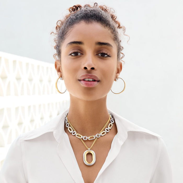 Model wearing Brighton two-tone layered link necklaces with hammered oval pendant and coordinating Brighton hoop earrings