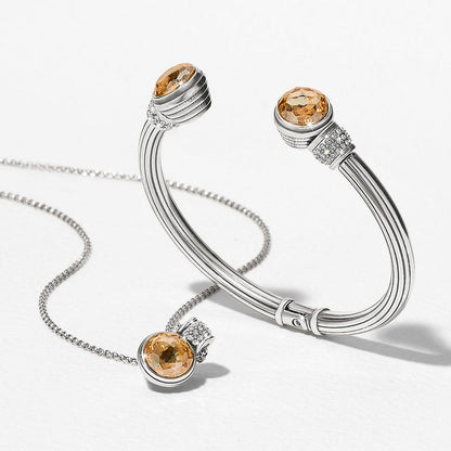 Brighton silver-plated cuff bracelet styled with a matching pendant necklace featuring amber crystals and pavé accents