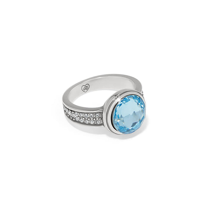 Brighton silver-plated ring with large round blue crystal and pavé crystal band accents on a white background