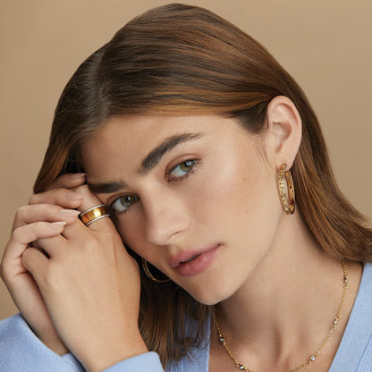 Model wearing Brighton gold-plated hoop earrings with coordinating gold-plated ring and crystal-accented necklace