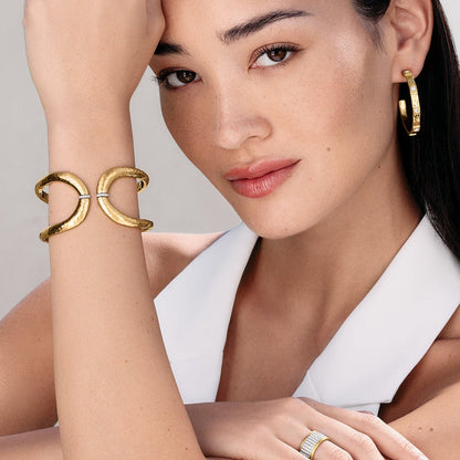 Model wearing Brighton gold-plated hammered cuff bracelets with crystal accents and coordinating Brighton accessories