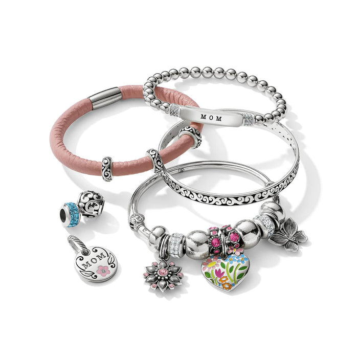 Brighton silver-plated bracelets styled with pink leather band and charms featuring floral heart, crystals, and MOM pendant