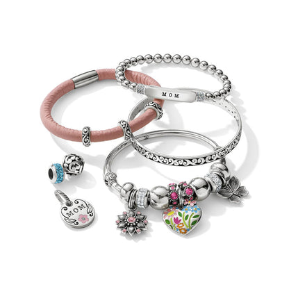 Brighton silver-plated bracelets styled with pink leather band and charms featuring floral heart, crystals, and MOM pendant