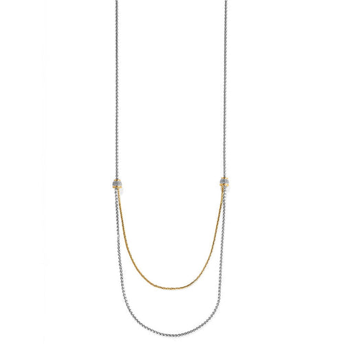 Brighton two-tone layered chain necklace with crystal-set beaded stations and draped gold and silver strands on a white background