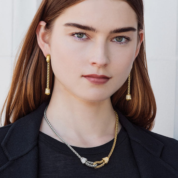 Model wearing Brighton gold-plated drop earrings with crystal accents paired with a two-tone chain necklace with crystals