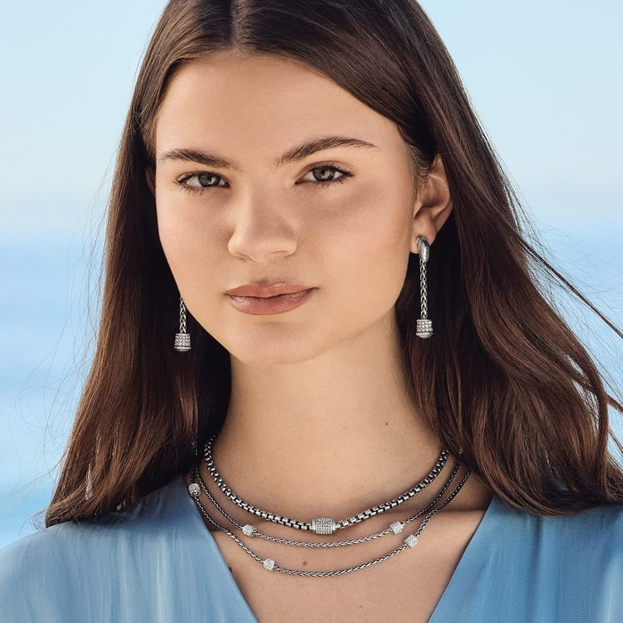 Model wearing Brighton silver-plated drop earrings with crystal accents paired with a layered chain necklace with crystal stations