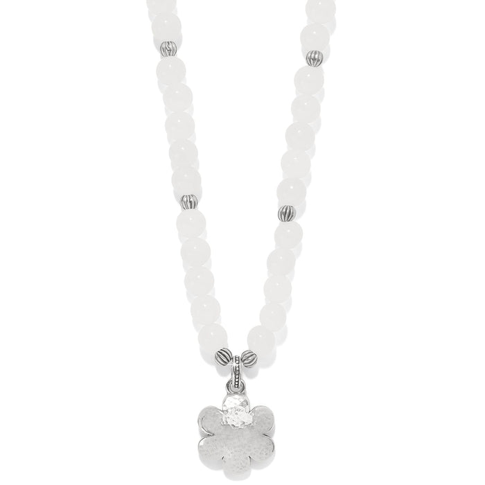 Brighton beaded necklace with white dyed jade beads and silver-plated flower pendant on a white background