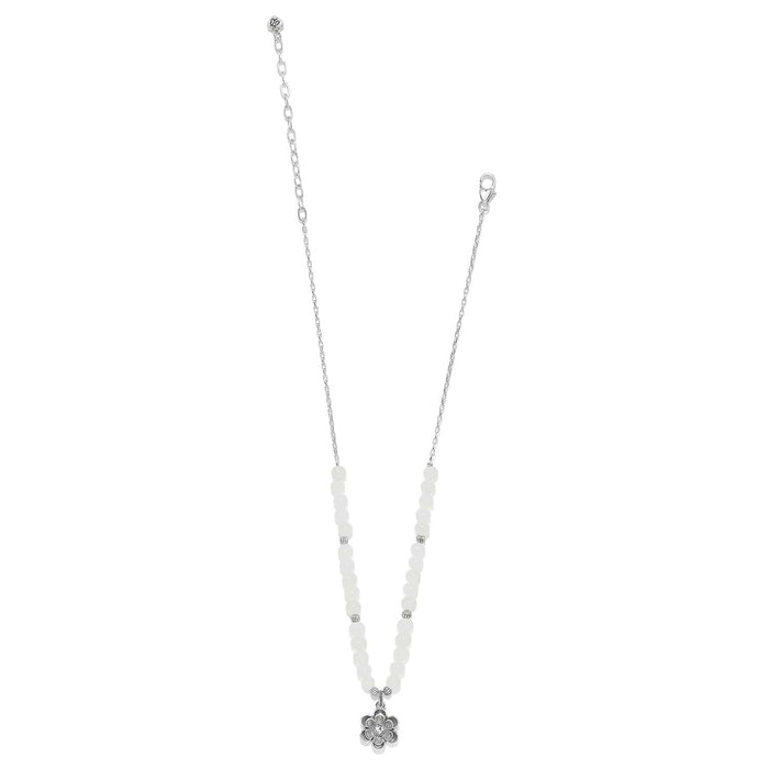 Brighton silver-plated necklace with white dyed jade beads and crystal flower pendant on a white background