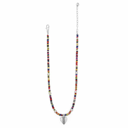 Brighton beaded necklace with multicolor heishi beads, potato pearls, silver-plated heart pendant and clasp on a white background