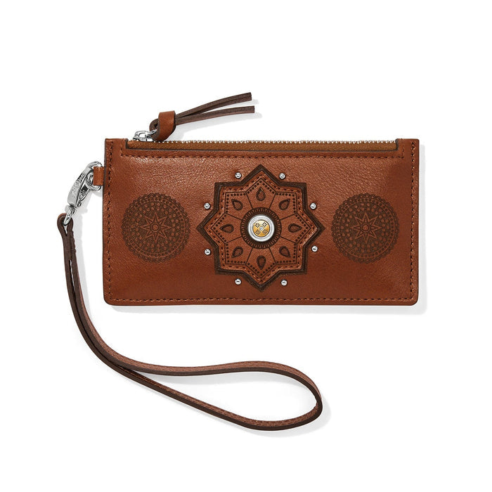 Brighton brown leather wristlet wallet with embossed medallion designs, zip top, and detachable strap on a white background