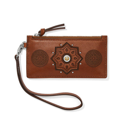 Brighton brown leather wristlet wallet with embossed medallion designs, zip top, and detachable strap on a white background