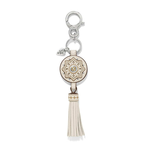 Brighton key fob with cream leather medallion, gold star pattern, tassel, and silver-tone clasp on a white background