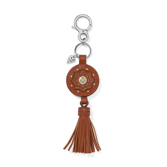 Brighton leather key fob with brown medallion, star motif, silver-tone clasp, and tassel on a white background