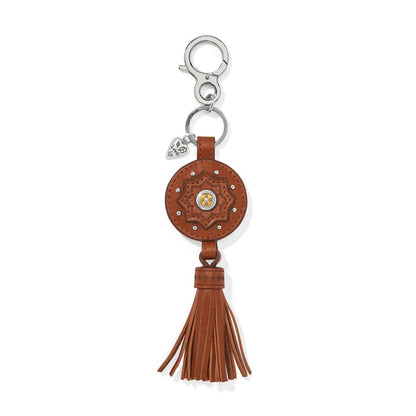 Brighton leather key fob with brown medallion, star motif, silver-tone clasp, and tassel on a white background