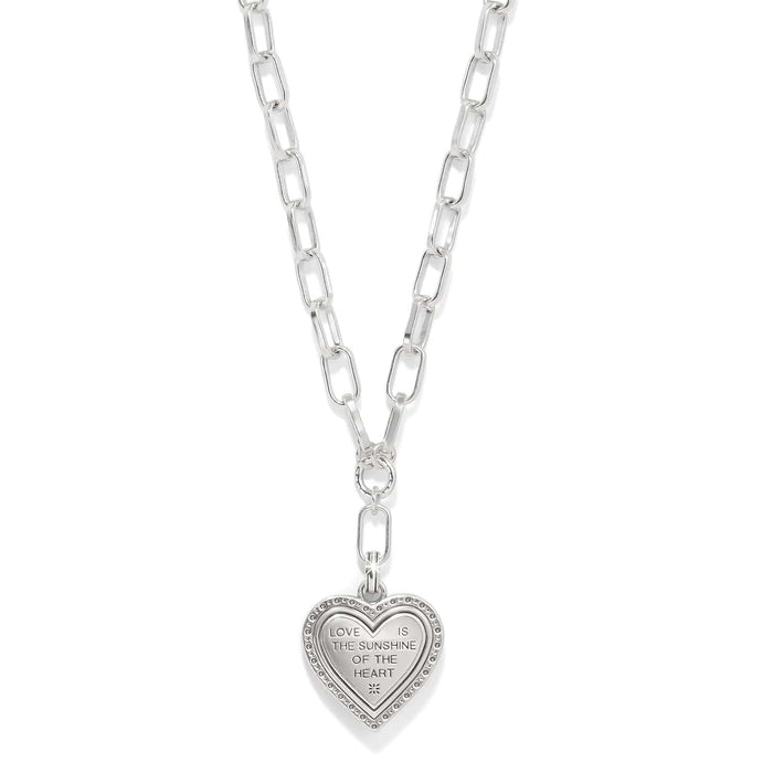 Brighton heart pendant necklace on silver-tone paperclip chain with engraved love message inscription on a white background