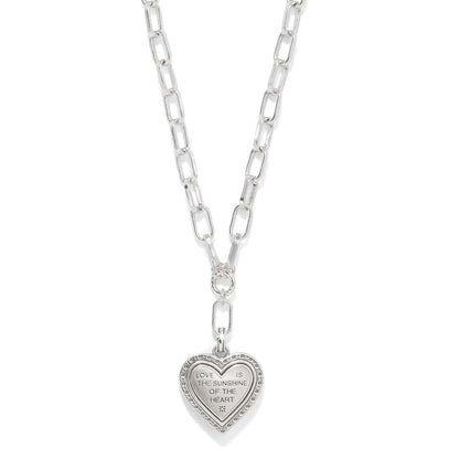 Brighton heart pendant necklace on silver-tone paperclip chain with engraved love message inscription on a white background