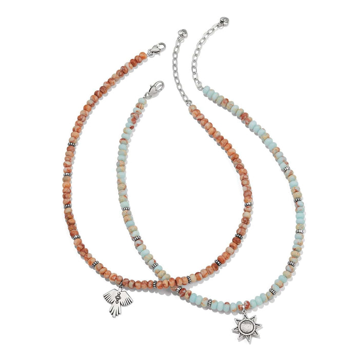 Brighton beaded necklaces with orange and aqua stones, silver-plated spacers, thunderbird and star pendants on a white background
