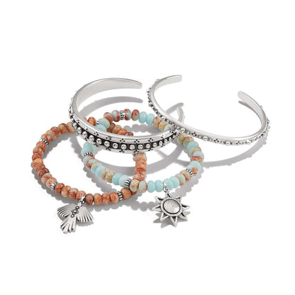 Brighton bracelet set with silver-plated cuffs and beaded strands featuring star and hand charms on a white background