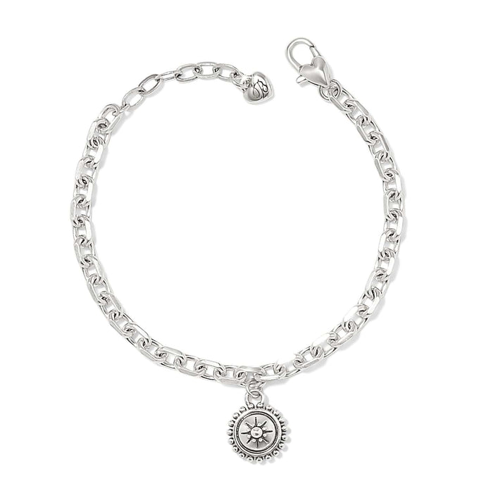 Brighton charm bracelet with silver-plated chain, lobster clasp, and round medallion charm with sunburst detail on a white background