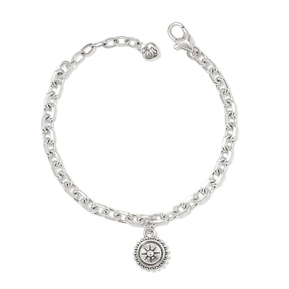 Brighton charm bracelet with silver-plated chain, lobster clasp, and round medallion charm with sunburst detail on a white background