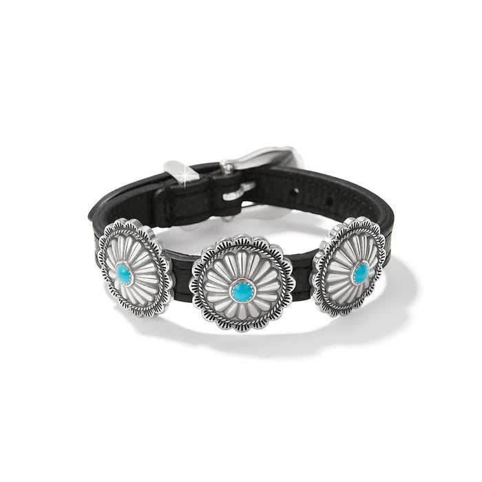 Brighton bracelet with black leather band, three silver-plated concho medallions with turquoise centers, on a white background