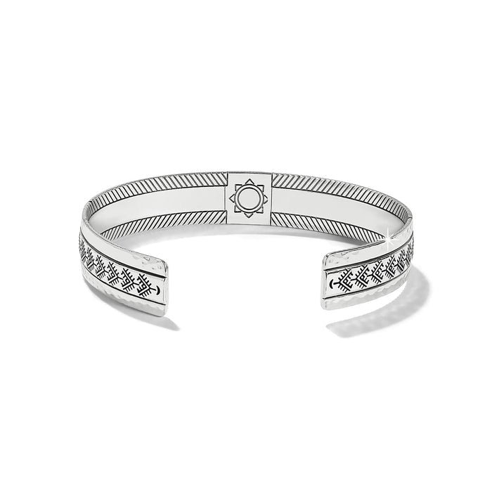 Brighton silver-plated cuff bracelet with hammered finish, engraved geometric patterns, and central medallion detail on a white background