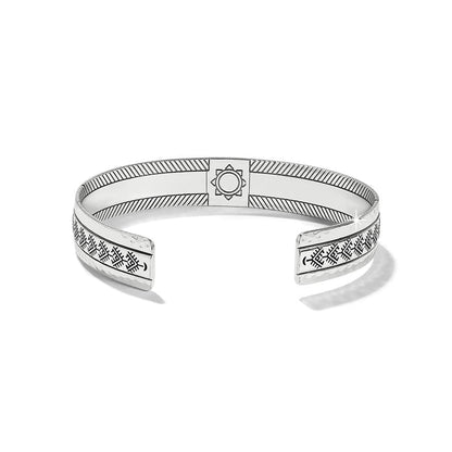 Brighton silver-plated cuff bracelet with hammered finish, engraved geometric patterns, and central medallion detail on a white background