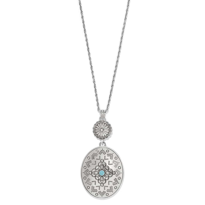 Brighton pendant necklace with silver-plated oval medallion, etched pattern, and turquoise enamel center stone on a white background