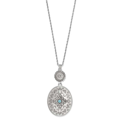 Brighton pendant necklace with silver-plated oval medallion, etched pattern, and turquoise enamel center stone on a white background