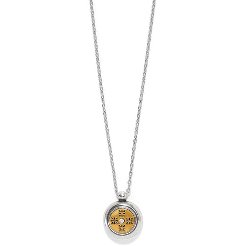 Brighton pendant necklace with two-tone round medallion, floral cutout design, and crystal accent on a white background