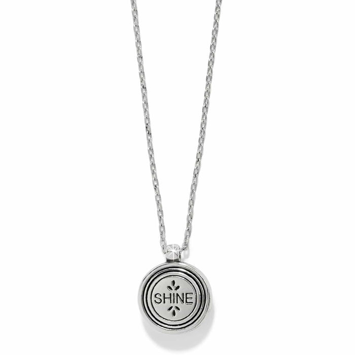 Brighton pendant necklace with round silver-tone medallion engraved with the word SHINE on a white background