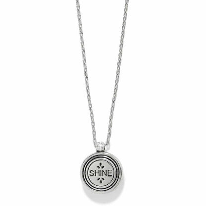 Brighton pendant necklace with round silver-tone medallion engraved with the word SHINE on a white background