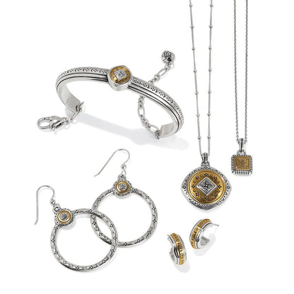 Brighton two-tone jewelry set styled with bracelet, necklaces, and earrings featuring silver and gold medallion details