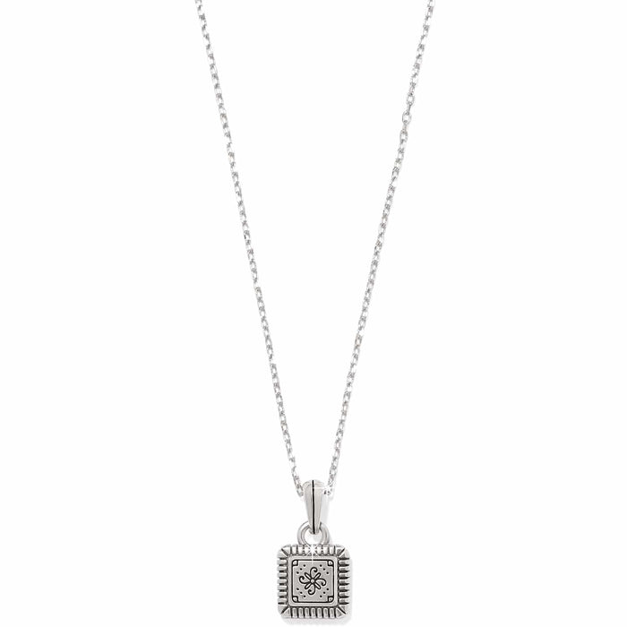 Brighton pendant necklace with small square silver-tone charm featuring engraved floral motif and ridged border on a white background