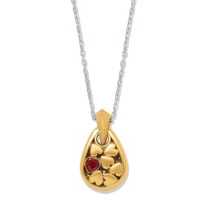 Brighton pendant necklace with two-tone teardrop charm, heart details, red crystal accent, and silver chain on a white background