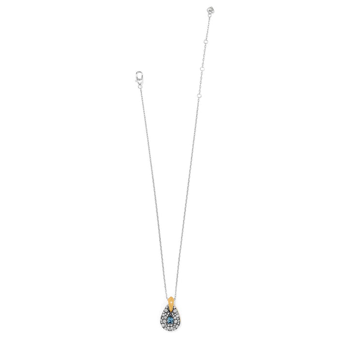 Brighton pendant necklace with two-tone teardrop charm, blue crystal center, and pavé crystal accents on a white background