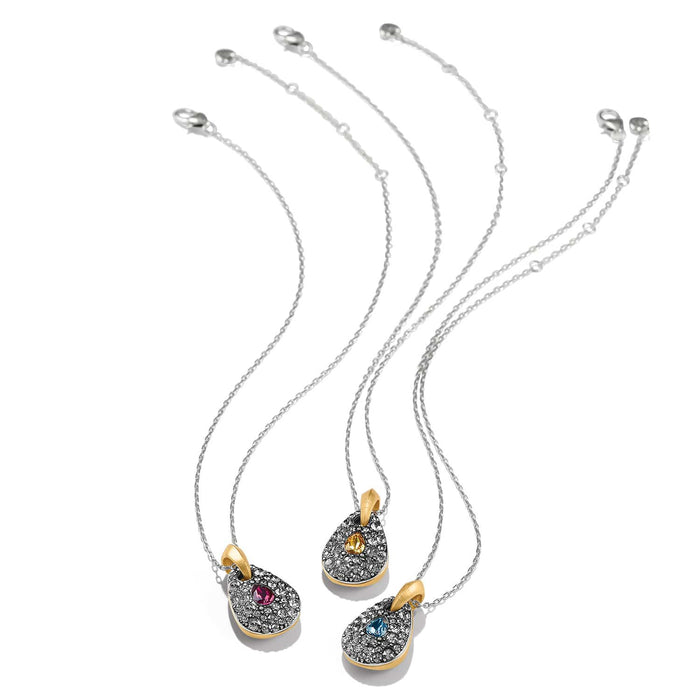 Brighton pendant necklaces with two-tone teardrop pendants featuring crystal pavé and pink, yellow, blue stones on a white background